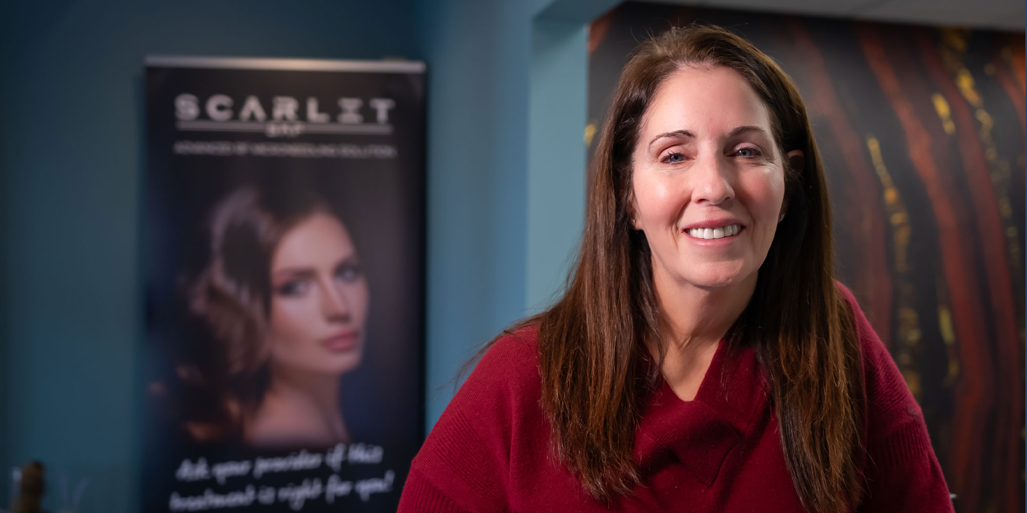 headshot of patient smiling brightly after their dental treatment