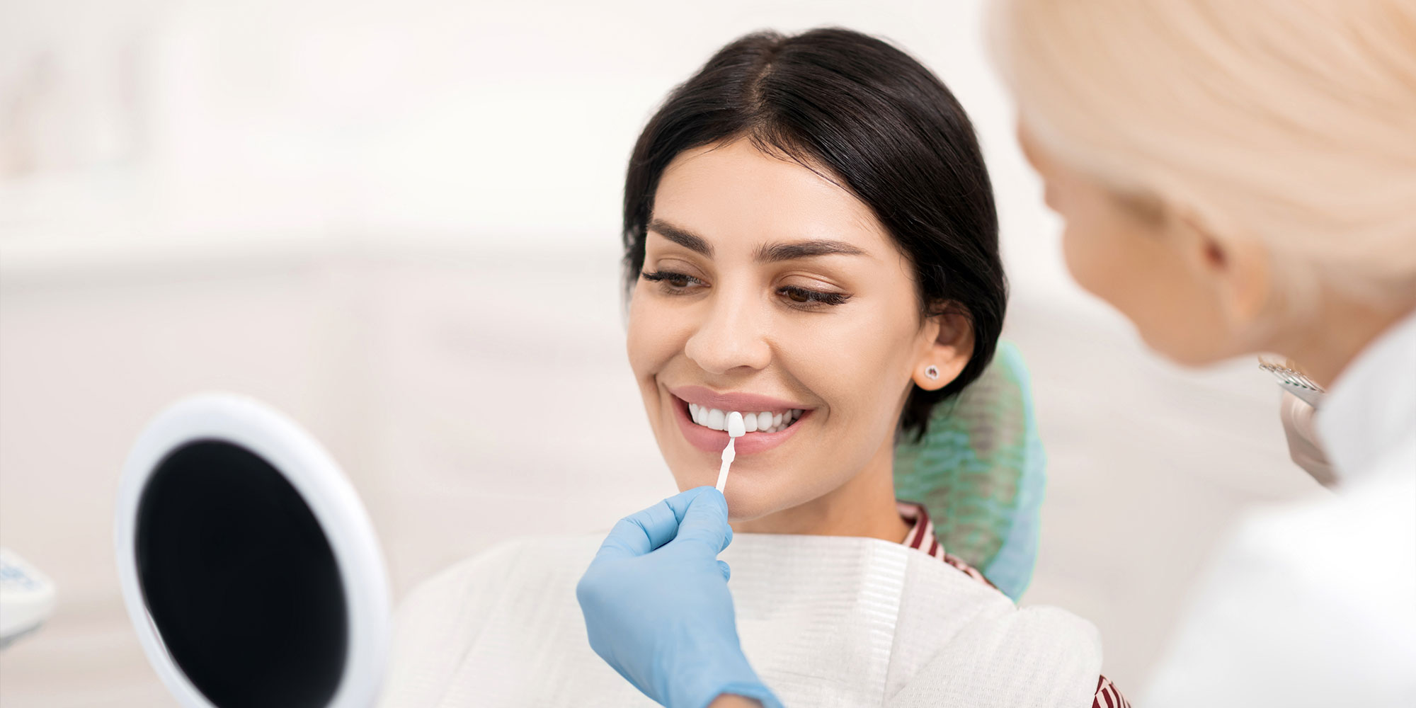 patient smiling brightly while getting their teeth whitening compared