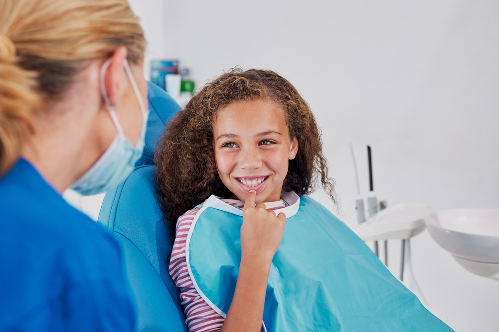Periodontist consulting with a patient at a dental clinic